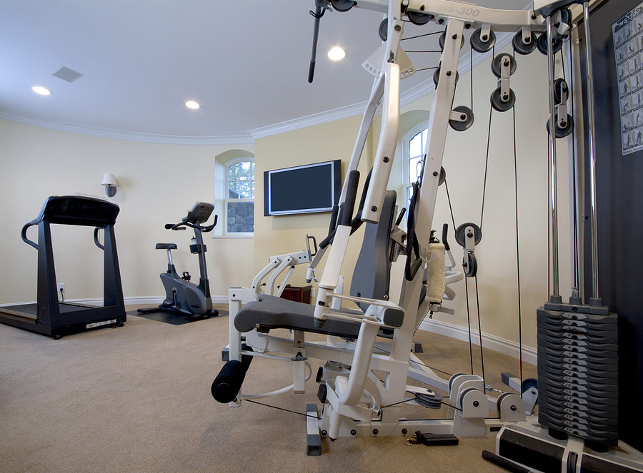 home gymnasium with televison in mansion private residence